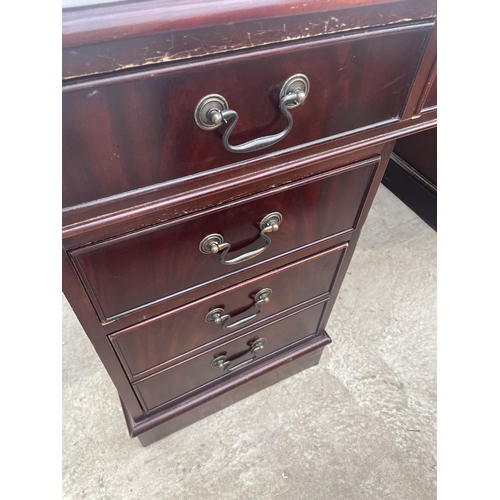 2507 - A MAHOGANY TWIN PEDESTAL DESK ENCLOSING EIGHT DRAWERS WITH INSET LEATHER TOP, 54X30