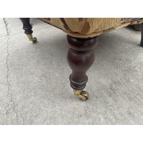 2680 - A 'STUART JONES' TUB CHAIR ON TURNED FRONT LEGS, WITH BRASS CASTERS