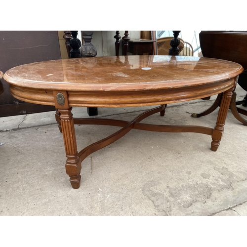 2711 - A PAIR OF OVAL COFFEE TABLES ON FLUTED LEGS WITH APPLIED EMBOSSED BRASS DECORATION