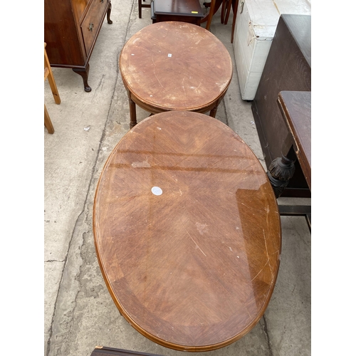 2711 - A PAIR OF OVAL COFFEE TABLES ON FLUTED LEGS WITH APPLIED EMBOSSED BRASS DECORATION