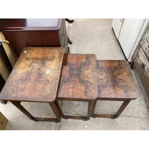 2740 - A NEST OF THREE ART DECO MID 20TH CENTURY WALNUT TABLES