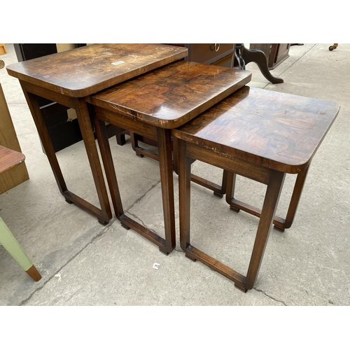 2740 - A NEST OF THREE ART DECO MID 20TH CENTURY WALNUT TABLES