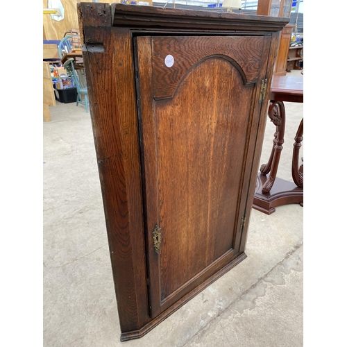 2743 - A GEORGE III OAK SINGLE DOOR CORNER CUPBOARD WITH H-BRASS HINGES AND SHAPED INTERIOR SHELVES, 26