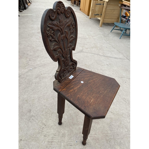 2747 - A VICTORIAN OAK HALL CHAIR WITH CARVED FOLIATE BACK