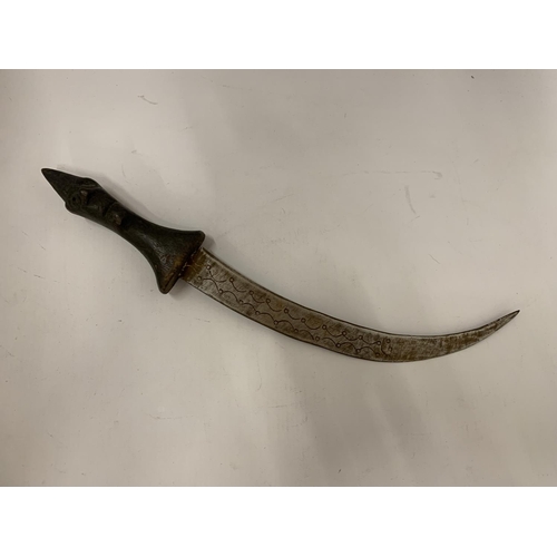 101 - A MIDDLE EASTERN STYLE DAGGER WITH CARVED FACE TO HANDLE