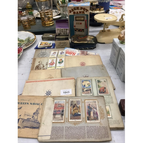 1043 - A QUANTITY OF CIGARETTE CARDS IN ALBUMS, LOOSE CARDS PLUS VINTAGE TINS, A JACKPOT BANK AND BRYANT AN... 