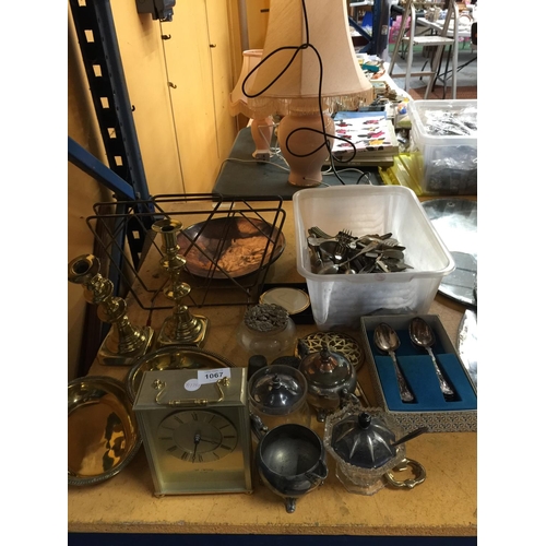 1067 - A LARGE MIXED LOT TO INCLUDE FLATWARE, A COPPER DISH, CARRIAGE CLOCK, BRASS CANDLESTICKS AND BOWLS, ... 