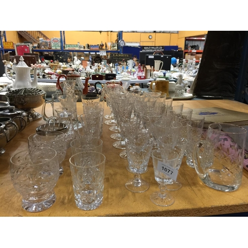 1077 - A LARGE QUANTITY OF GLASSES TO INCLUDE WINE, SHERRY, WHISKY TUMBLERS PLUS A TANKARD, JUGS, VASES, ET... 