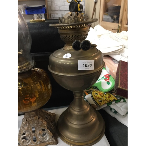 1090 - TWO VINTAGE OIL LAMPS ONE WITH A PIERCED BRASS BASE AND AMBER GLASS MIDDLE