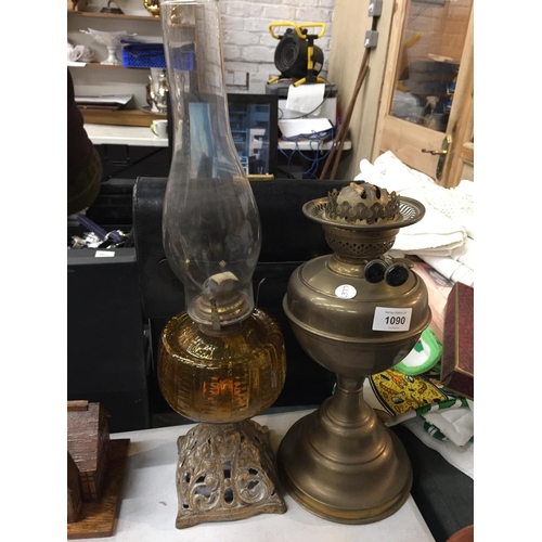 1090 - TWO VINTAGE OIL LAMPS ONE WITH A PIERCED BRASS BASE AND AMBER GLASS MIDDLE