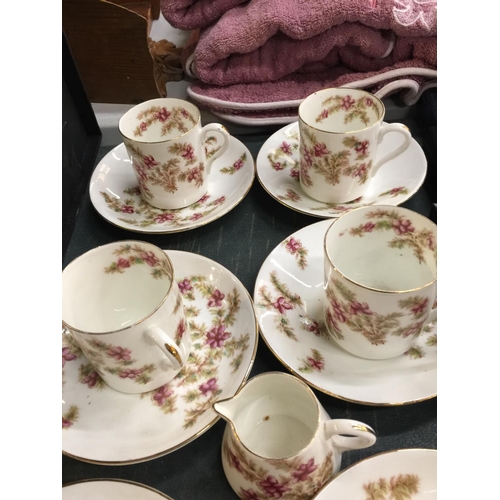 1103 - AN ANTIQUE TEA SET WITH FLORAL PATTERN TO INCLUDE CUPS, SAUCERS, A CREAM JUG AND SUGAR BOWL