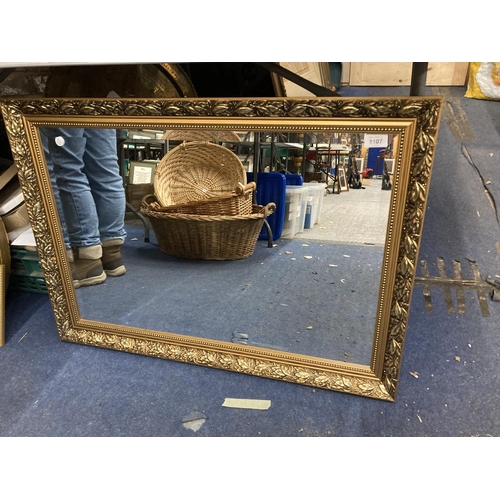 1107 - A BEVELLED EDGED GILT FRAMED WALL MIRROR 87CM X 61CM