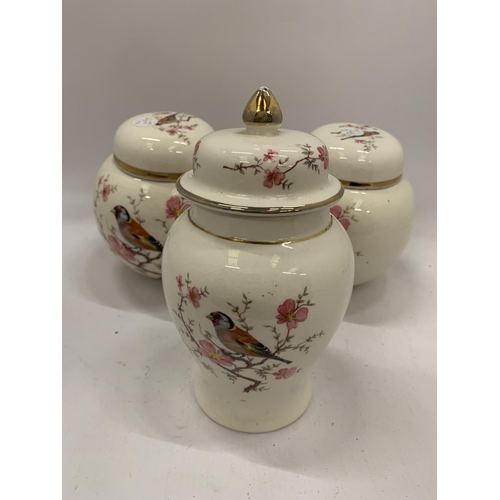 131 - TWO ARTHUR WOOD GINGER JARS AND A TEMPLE JAR WITH BIRDS AND BLOSSOM DESIGN