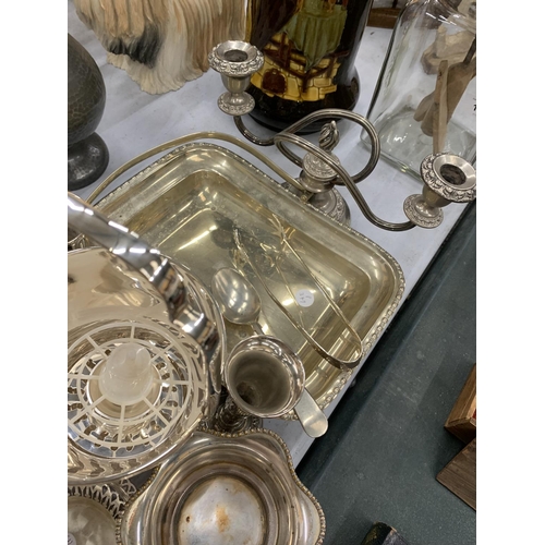 136 - A QUANTITY OF SILVER PLATED ITEMS TO INCLUDE ROSE BOWLS, A CANDLEABRA, BUD VASES, A HANDLED SERVING ... 