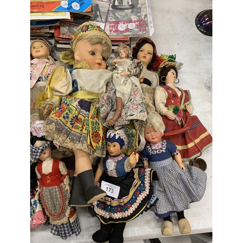 173 - A LARGE QUANTITY OF VINTAGE DOLLS IN TRADITIONAL COSTUME TO INCLUDE CERAMIC AND CLOTH