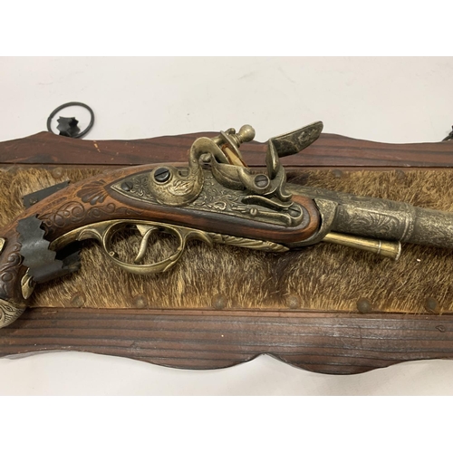 233 - A REPLICA PISTOL ON A WOODEN WALL MOUNT