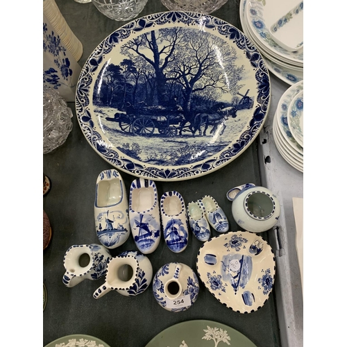 254 - A QUANTITY OF BLUE AND WHITE DELFT POTTERY TO INCLUDE A LARGE PLATE WITH HORSE AND CART DESIGN, CLOG... 