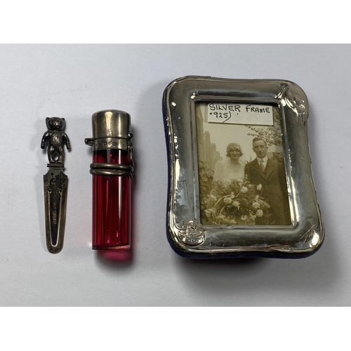 525 - THREE HALLMARKED SILVER ITEMS - BEAR BOOKMARK, SMALL PHOTO FRAME AND CRANBERRY GLASS PERFUME BOTTLE