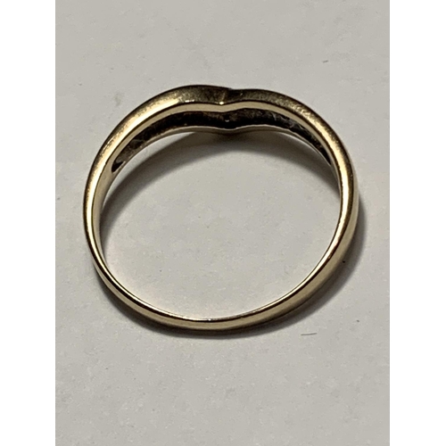 530 - A 9 CARAT GOLD WISHBONE RING WITH FOUR DIAMONDS SIZE M