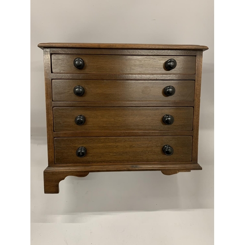 57 - A MAHOGANY FOUR DRAWER TABLE TOP CHEST OF DRAWERS, HEIGHT 28CM