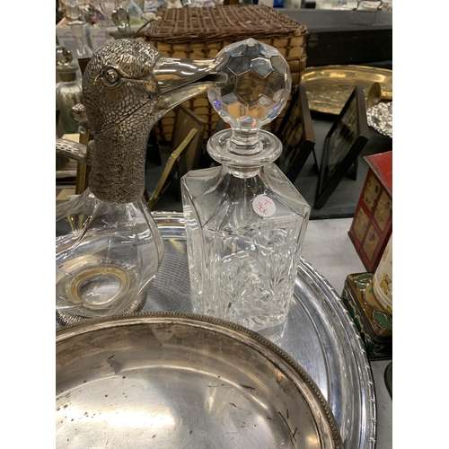 913 - A GLASS AND SILVER PLATED WATER JUG WITH DUCK HEAD, A CUT GLASS DECANTER PLUS TWO SILVER PLATED TRAY... 