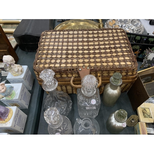 920 - A WICKER PICNIC BASKET PLUS A QUANTITY OF GLASS DECANTERS