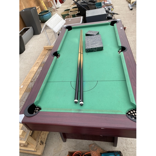 1874 - A LARGE POOL TABLE WITH TWO CUES AND A SET OF BALLS