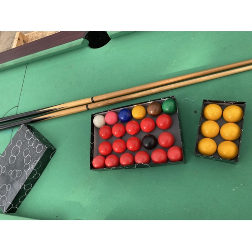 1874 - A LARGE POOL TABLE WITH TWO CUES AND A SET OF BALLS