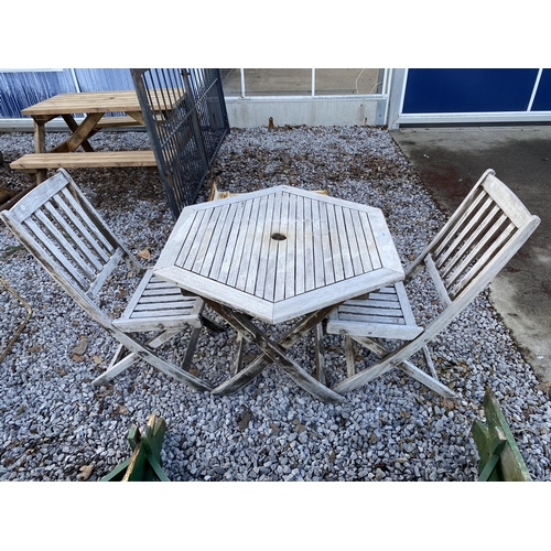 2028 - A WOODEN PATIO SET COMPRISING OF A TABLE AND TWO CHAIRS