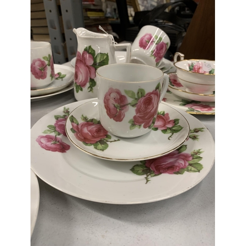 1153 - A VINTAGE ROSE PATTERNED TEASET TO INCLUDE A TEAPOT, CREAM JUG, SUGAR BOWL, CUPS, SAUCERS AND PLATES