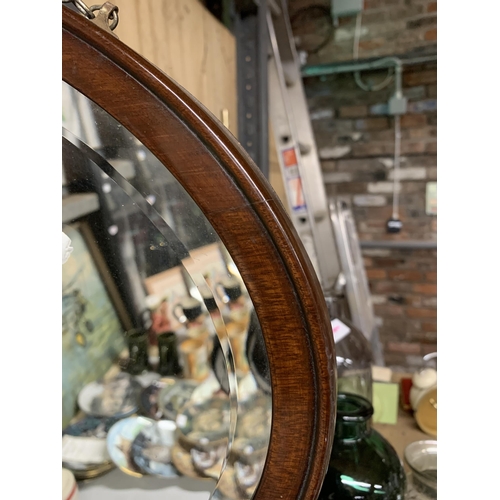 1185 - A MAHOGANY FRAMED OVAL MIRROR