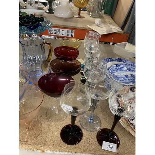 869 - A LARGE QUANTITY OF COLOURED GLASSWARE TO INCLUDE VARIOUS GLASSES, JUGS, PEDESTAL BOWLS, FRUIT, COCK... 