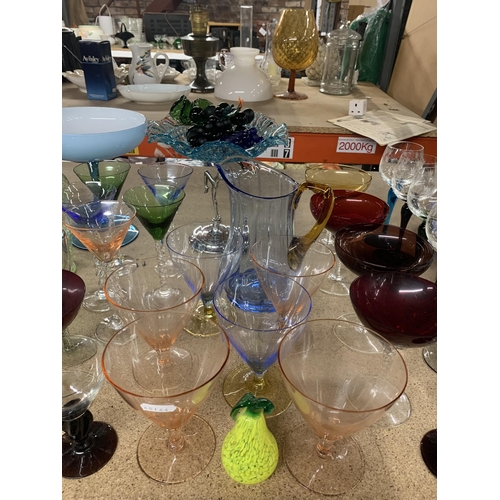 869 - A LARGE QUANTITY OF COLOURED GLASSWARE TO INCLUDE VARIOUS GLASSES, JUGS, PEDESTAL BOWLS, FRUIT, COCK... 