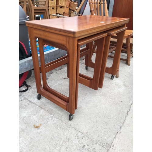 2863 - A RETRO TEAK 'MCINTOSH TRIFORM' NEST OF THREE TABLES WITH FOLD-OVER TOP