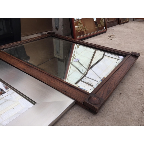 2865 - AN OAK FRAMED WALL MIRROR AND SILVER COLOURED MIRROR