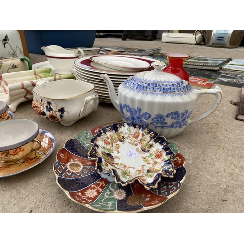 2127 - AN ASSORTMENT OF CERAMICS TO INCLUDE PLATES AND CUPS AND SAUCERS ETC