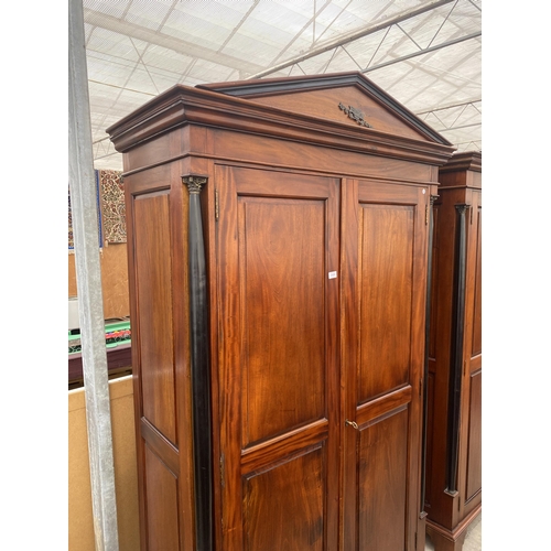 2884 - A MODERN HARDWOOD TWO DOOR WARDROBE WITH EBONISED CORINTHIAN COLUMNS, ON BRACKET FEET, 49.5