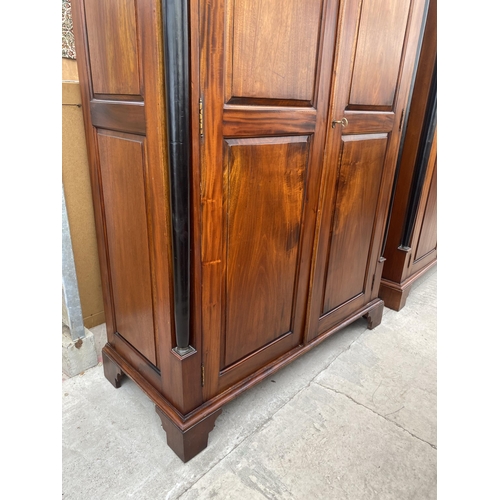 2884 - A MODERN HARDWOOD TWO DOOR WARDROBE WITH EBONISED CORINTHIAN COLUMNS, ON BRACKET FEET, 49.5