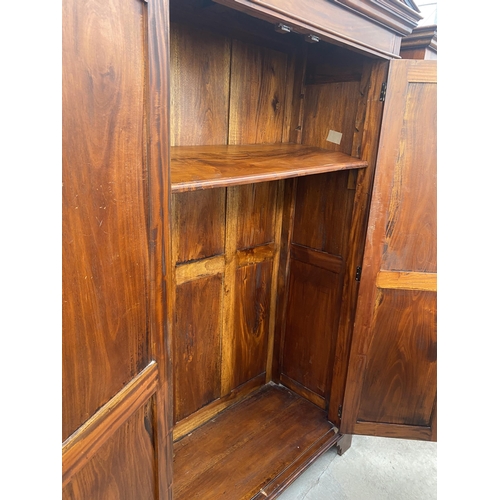 2884 - A MODERN HARDWOOD TWO DOOR WARDROBE WITH EBONISED CORINTHIAN COLUMNS, ON BRACKET FEET, 49.5