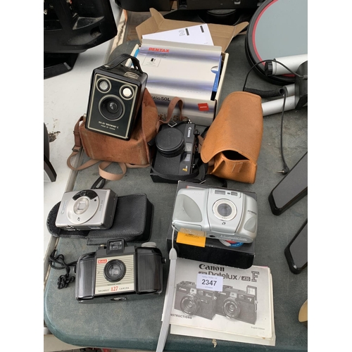 2347 - AN ASSORTMENT OF CAMERA EQUIPMENT TO INCLUDE A KODAK BROWNIE AND TWO CANON CAMERAS