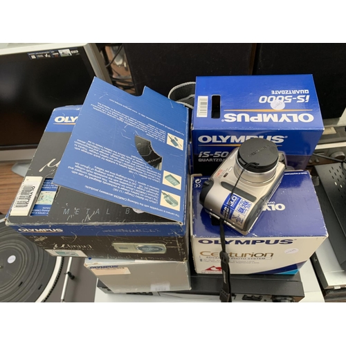 2404 - FOUR BOXED OLYMPUS CAMERAS TO INCLUDE A CENTURIAN, MJU, IS5000 AND IXE-3 PLUS VHS AND DVD PLAYERS