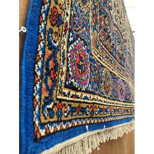 2492 - A VIBRANT BLUE PATTERNED FRINGED RUG