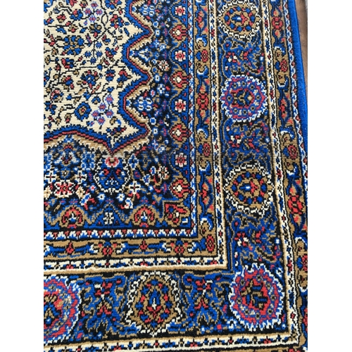 2492 - A VIBRANT BLUE PATTERNED FRINGED RUG