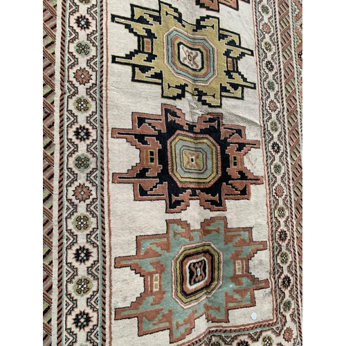 2496 - A LARGE PATERNED FRINGED RUG