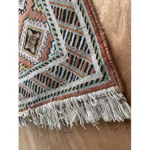 2496 - A LARGE PATERNED FRINGED RUG