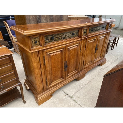 2938 - AN ANTIQUE STYLE HARDWOOD SIDEBOARD WITH TWO LONG & TWO SMALL FRIEZE DRAWERS ALL WITH FOLIATE DECORA... 