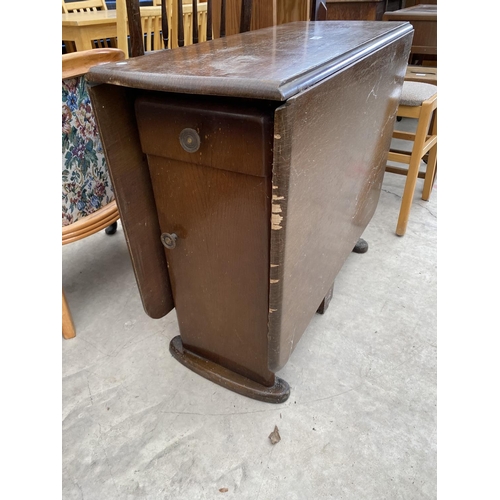 2942 - A MID 20TH CENTURY OAK DROP LEAF DINING TABLE WITH TWO END CUPBOARDS AND ONE DRAWER