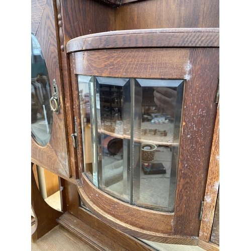 2956 - AN OAK ART NOUVEAU MIRROR BACK SIDEBOARD WITH OVAL GLASS DOORS TO UPPER PORTAL 43 INCH WIDE