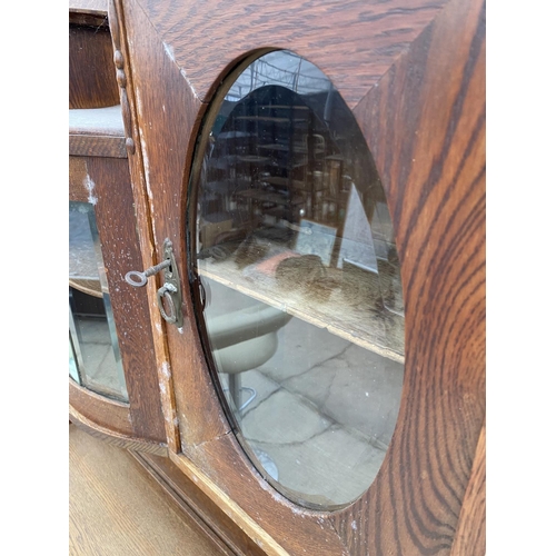 2956 - AN OAK ART NOUVEAU MIRROR BACK SIDEBOARD WITH OVAL GLASS DOORS TO UPPER PORTAL 43 INCH WIDE