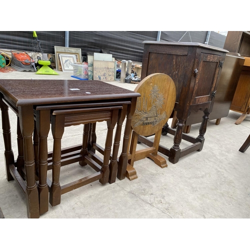 2968 - A NEST OF 3 TABLES, A HARDWOOD ORIENTAL STYLE FOLDING TABLE AND AN OAK BEDSIDE LOCKER